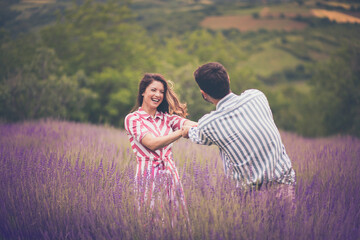 Young couple having fun on lavender field.