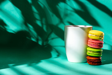 Obraz premium White cup and French almond cake. Morning light from the window