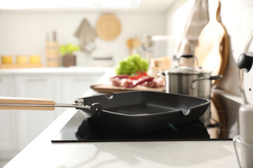 Frying pan with cooking oil on cooktop in kitchen