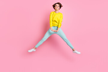 Fototapeta na wymiar Full size photo of young attractive cheerful positive careless funky girl jumping isolated on pink color background
