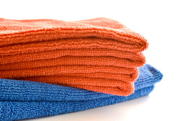 Orange and blue microfiber cloth on white background.