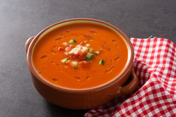 Gazpacho soup in crock pot on black stone. 