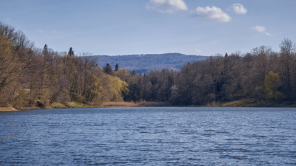Beautiful lake overlooking the forest and mountains. Beautiful landscape of a mountain lake.