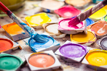 Set of watercolor paints and paintbrushes for painting closeup.