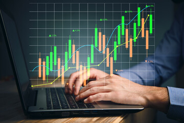 Hands typing the keyboard to research stock market