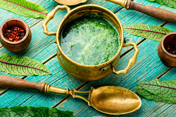 Green sorrel soup,wooden table