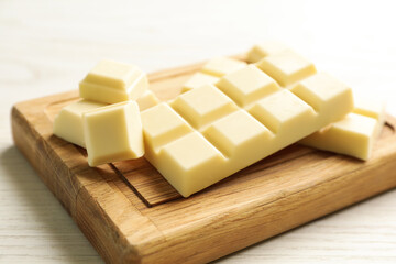 Delicious white chocolate on wooden table, closeup