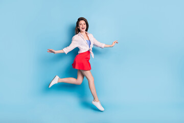 Full body profile portrait of energetic cheerful girl rush toothy smile look camera isolated on blue color background © deagreez