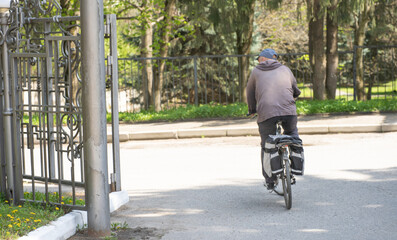 Aged man rides a bicycle