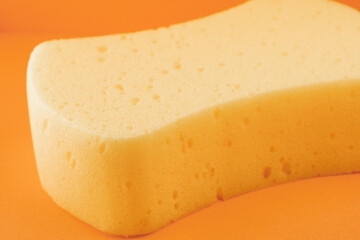 Yellow sponge on orange background