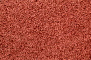 Decorative plaster of terracotta color with small pimples, wall surface.Overlay texture for interior or exterior design.Decorative render.Single-ply monolithic plaster decorative background and sample