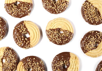 Almond tea biscuits partially covered in chocolate, round cookies isolated on white background