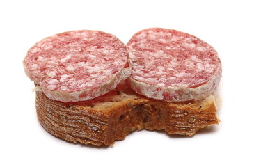 Fermented semi-hard dried sausage slices on piece of bread, pig meat isolated on white background