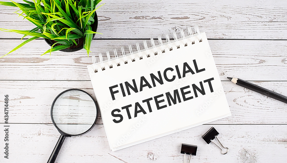 Poster financial statement text concept write on notebook with office tools on the wooden background
