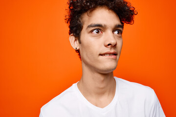 cute guy curly hair white t-shirt modern style orange background