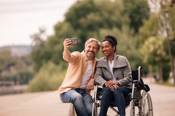 Smiling lovers taking a picture together using phone camera.