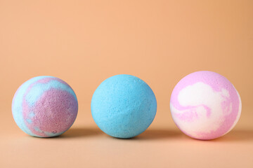 Different colorful bath bombs on beige background