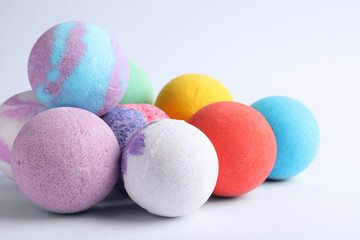 Pile of colorful bath bombs on white background, closeup