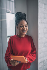 African american cute woman with a tablet looking excited