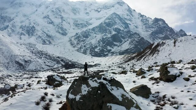 Hiker standing on rock enjoying mountain view on the way to Nanga Parbat