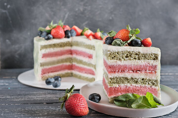 vegetarian non dairy cake. multi layered matcha and strawberry dessert with berries and mint decor....