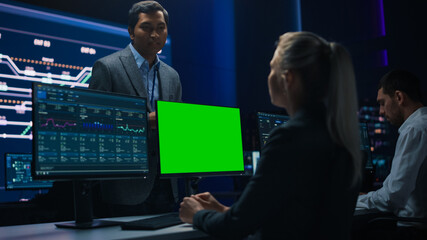 Female Specialist Works on Green Screen Computer Talks with Project Manager in Big Infrastructure...