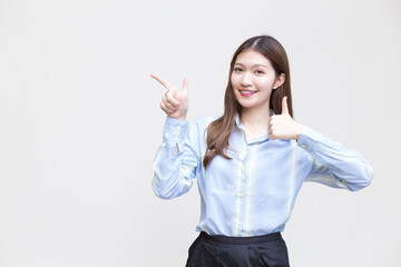 Beautiful business woman who has long hair Asian with a blue shirt smiles and shows thumb up to present something on a white background.