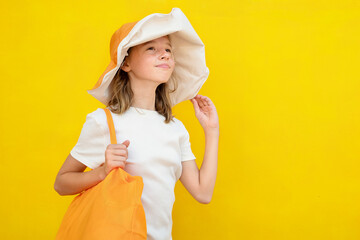 Portrait of a child on vacation on a yellow background.