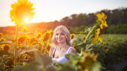 Fototapeta na wymiar Young woman in sunflower field enjoying nature, Ukraine