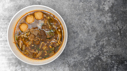 Top view Stewed pork soup with meatballs on the gray concrete table.