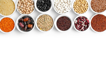Various raw veggie seeds in bowls on white background, top view