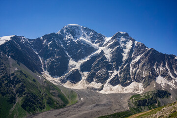 Glacier Seven on mount Donguzorun. View from Mount Cheget, Kabardino Balkaria region. Russia. Altitude is 3000 metres. Lifting on Cable Car. - obrazy, fototapety, plakaty