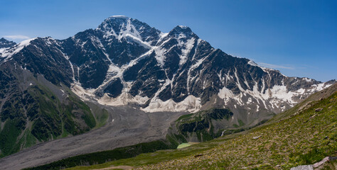 Panoramic view of Glacier Seven on mount Donguzorun. Panoramic view from Cheget mount, Kabardino Balkaria region. Russia. 3000 metres height. Lifting on Cable Car. View on Donguzorun peak on left and - obrazy, fototapety, plakaty