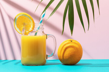 Orange juice in a glass on a colored background