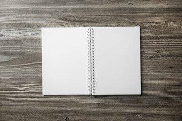 Blank paper brochure on wooden table, top view. Mockup for design