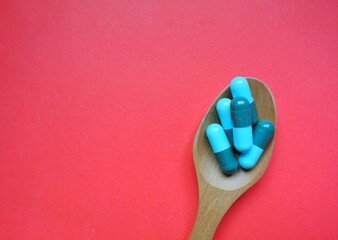 Tablets on a wooden spoon.Antibiotics.