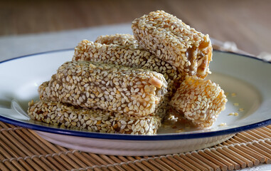 Duck Neck Snacks in white dish, and Chinese tea,  Dessert of Chinese put on bamboo mat and brown wooden table,