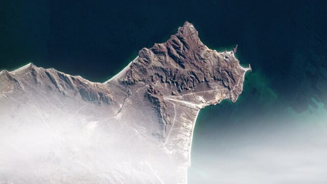 Flying over Baja California coastline, clouds over Punta Arena de la Ventana animation. Image furnished by Nasa