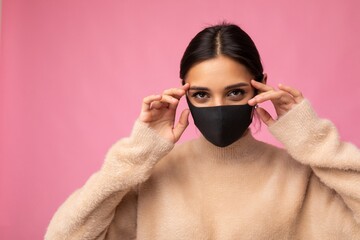 Brunette woman wearing an anti virus protection mask to prevent others from corona COVID-19 and...