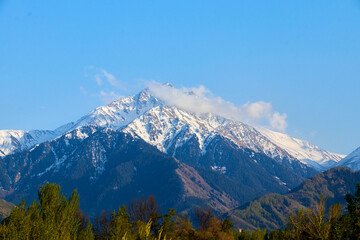 view of the snow-capped mountains landscape with blue sky