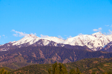 view of the snow-capped mountains landscape with blue sky