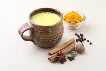 turmeric milk or haldi milk, Indian traditional home remedy. turmeric milk with star anise, black pepper, cinnamon, cardamom, nutmeg, clove,