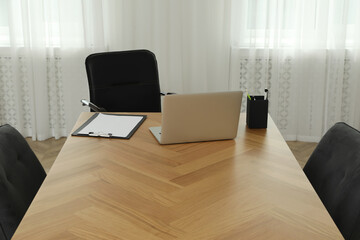 Director's office with large wooden table and comfortable armchairs. Interior design
