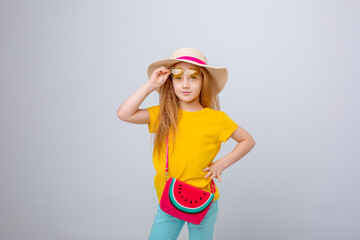 a little girl in sunglasses and a traveler hat on a white background