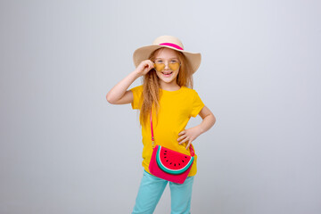 a little girl in sunglasses and a traveler hat on a white background