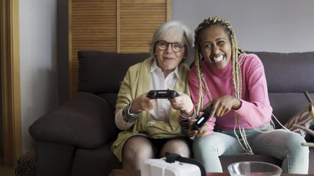 Multi generational gamers playing game online at home - Multiracial, elderly technology trends