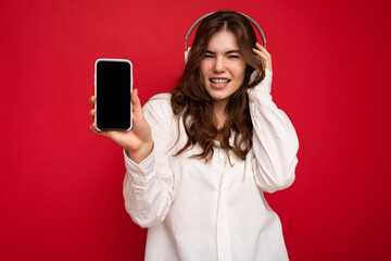 Beautiful happy smiling young woman wearing stylish casual outfit isolated on background wall...