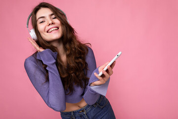 Beautiful happy smiling young woman wearing stylish casual outfit isolated on background wall...