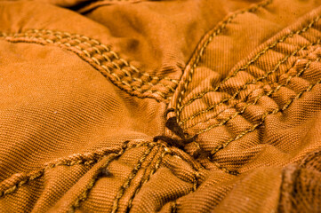 clothing items stonewashed cotton fabric texture with seams, clasps, buttons and rivets, macro