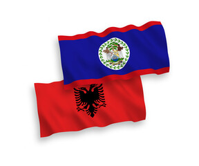 National vector fabric wave flags of Belize and Albania isolated on white background. 1 to 2 proportion.